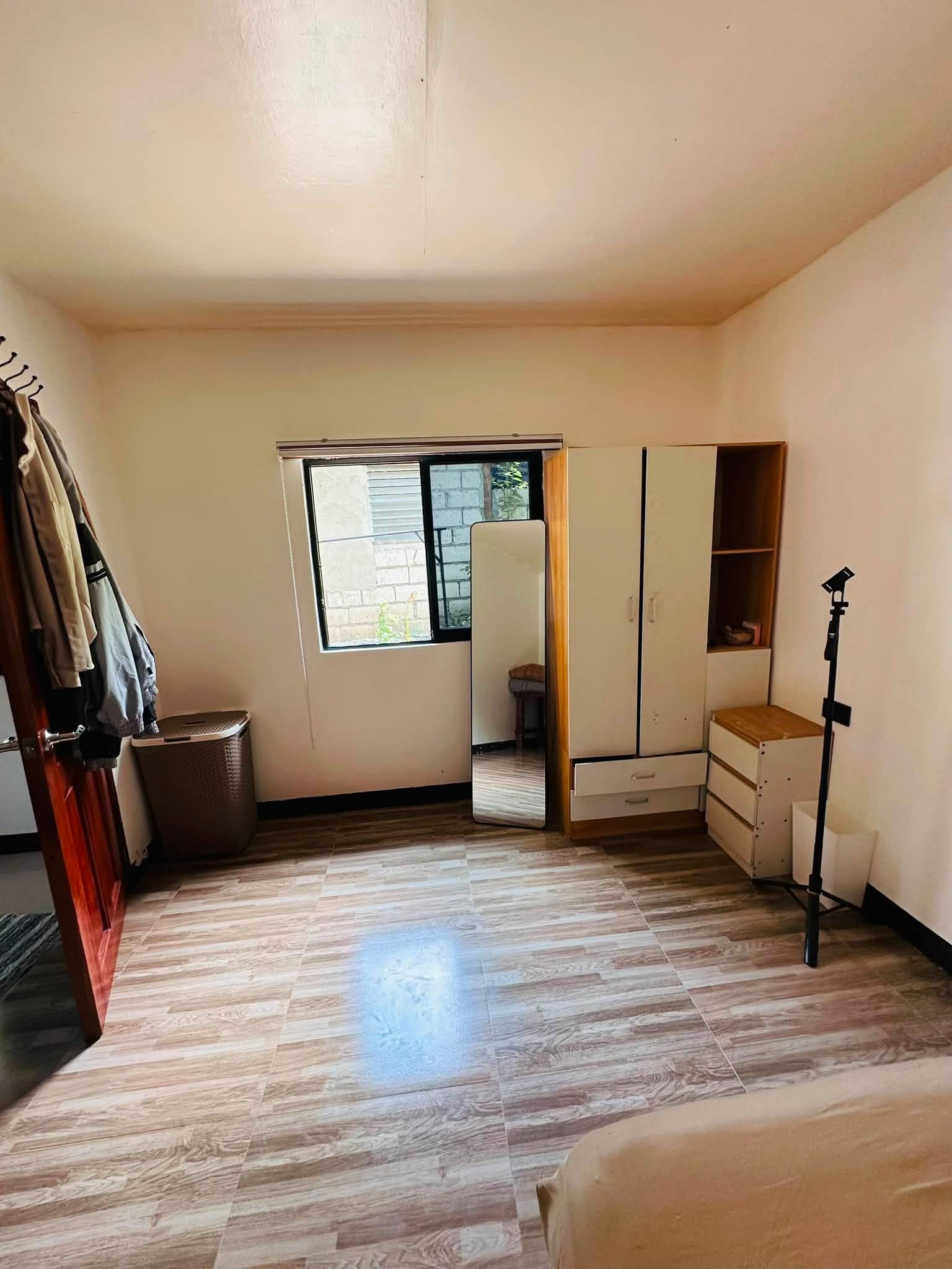Master bedroom with a wardrobe, full-length mirror, dresser and a window with blinds